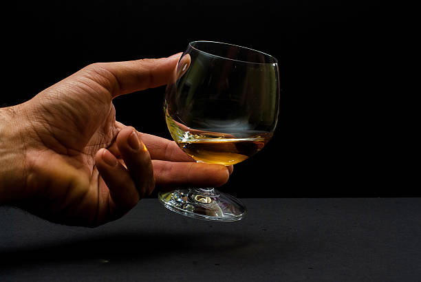 istock Cognac glass in human hand 475116326