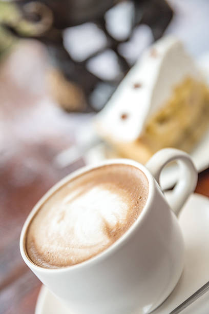 istock Cup of latte coffee with cake 475117438