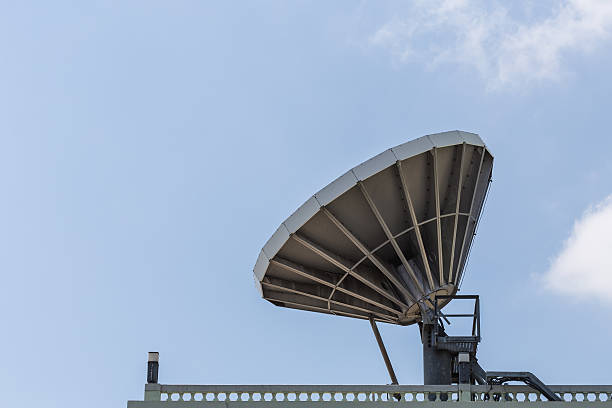 Big satellite dish on the roof Big satellite dish on the roof with blue sky background parabol stock pictures, royalty-free photos & images