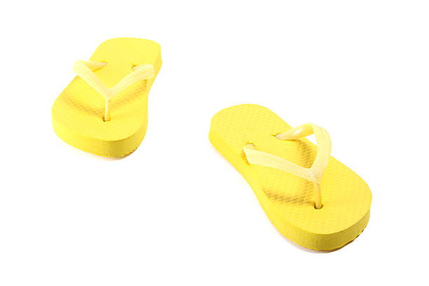 istock picture of yellow flip flops over white 475124808