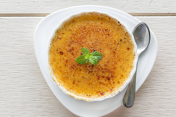 istock creme brulee in bowl garnished with mint leaves 475125550