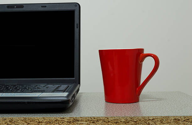 istock red cup on wooden desk with labtop 475125882