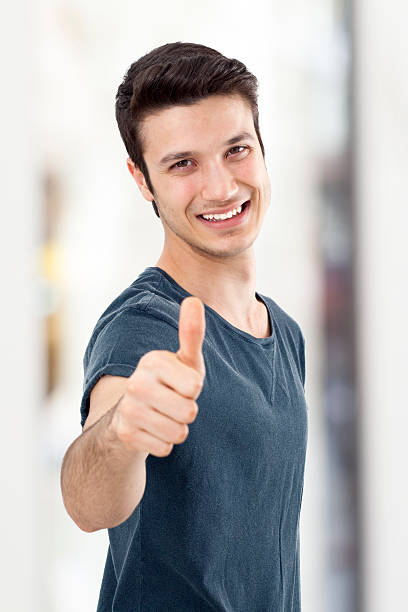 istock Young man showing OK sign with his thumb up 475126224