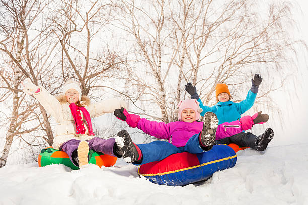 istock Excited children sliding down on the tubes 475129572