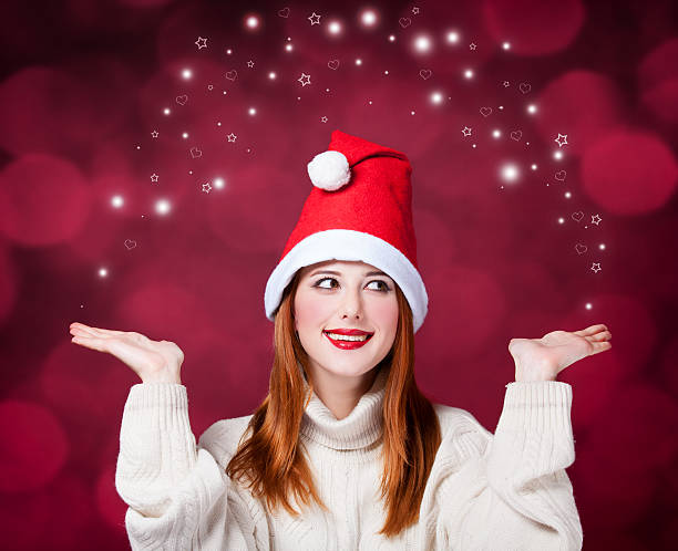 istock Redhead girl in christmas hat 475132051