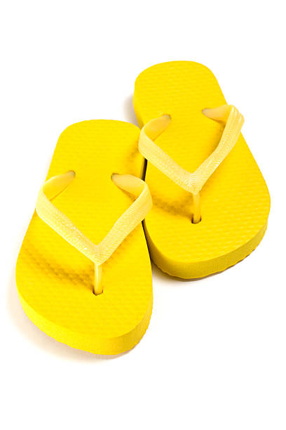 istock yellow summer flip flop shoes over white 475132474