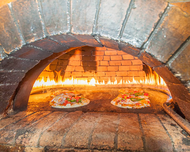 istock Pizzas cooking in an open oven 475132877