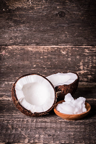 istock coconuts and oil on wooden table 475134034