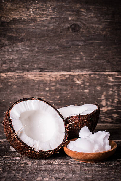 istock coconuts and oil on wooden table 475134038