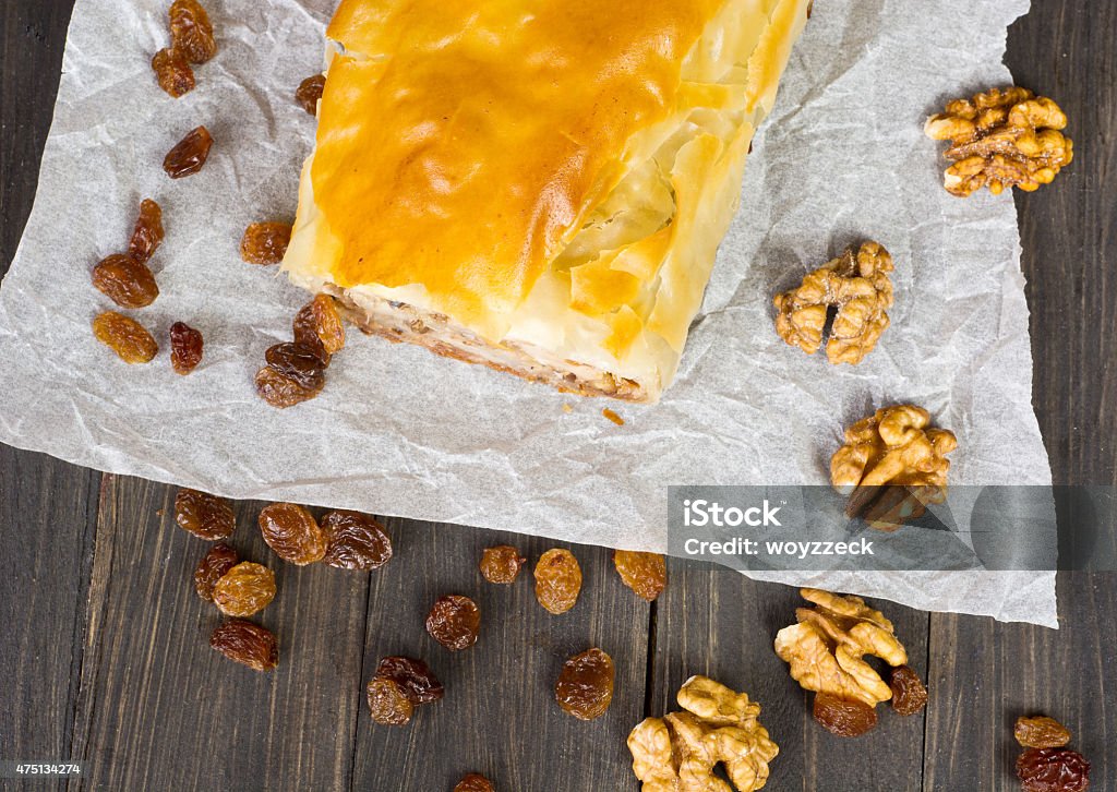 Apple pie Apfelstrudel (apple pie) made of filo pastry with raisins and walnuts 2015 Stock Photo