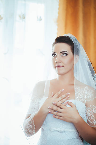 istock beautiful bride getting ready in white wedding dress with hairstyle 475134488