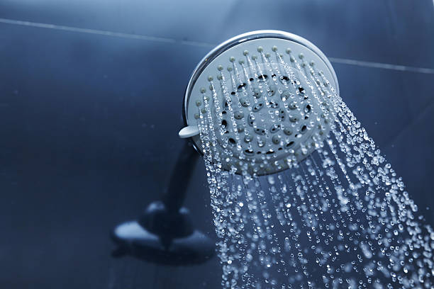 istock shower head in bathroom with water drops flowing 475134592
