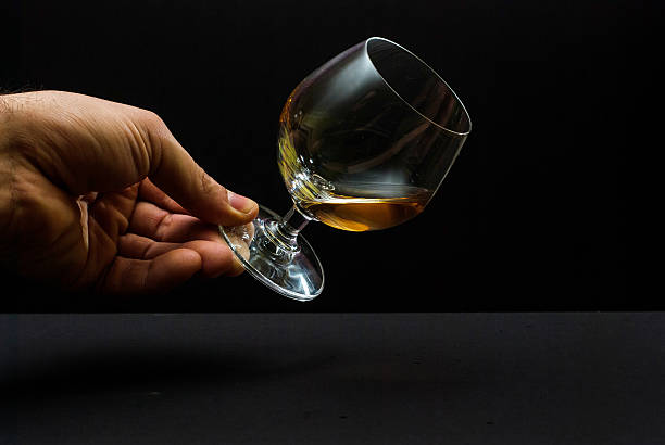 istock Cognac glass in human hand 475135494