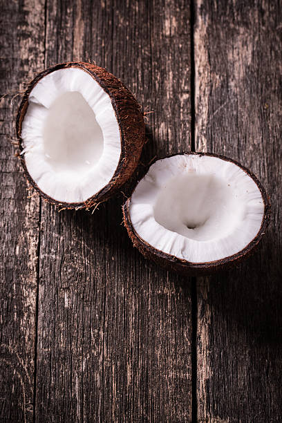 istock coconuts and oil on wooden table 475138746