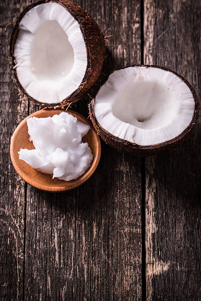istock coconuts and oil on wooden table 475138748