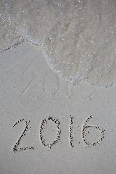 istock Numbers 2016 on beach - concept holiday background 475138790