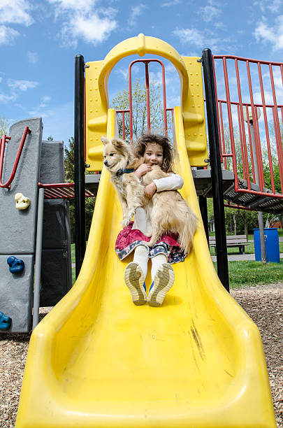 istock Girl sliding with her dog 475138922
