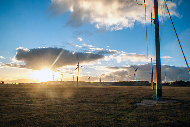 istock wind turbines and power lines in a field 475140038