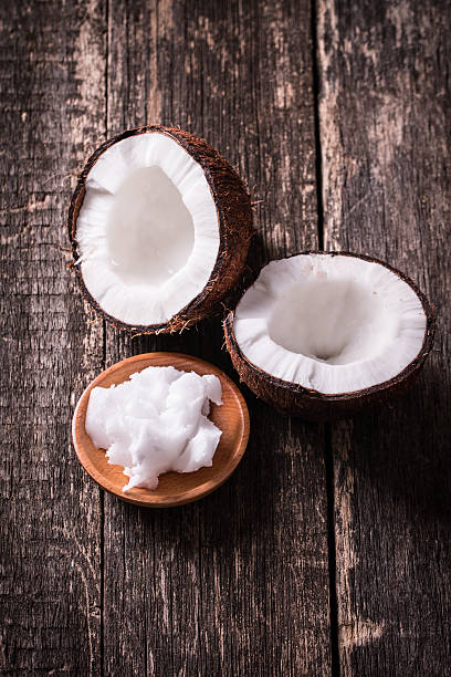 istock coconuts and oil on wooden table 475142722