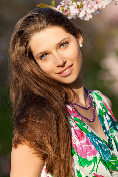 istock Beautiful  brunette woman in blooming orchard 475142968