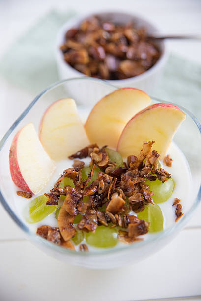 istock Home made granola with yoghurt, apple and grapes 475143294