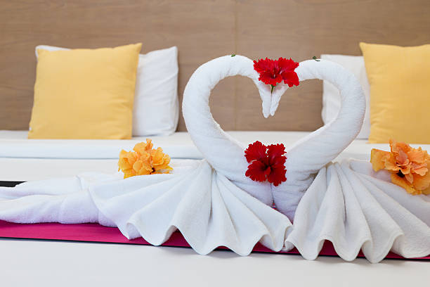 istock white swans made from towels on bed in the hotel 475143792