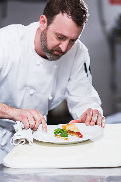 istock Chef in a restaurant plating food 475144452