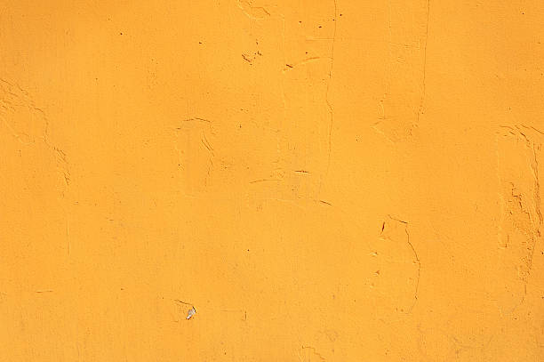 istock Texture of old wall covered with yellow stucco 475144930