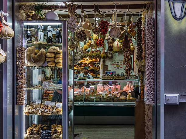 Naples, Italy - May 10, 2015: Food store in Spaccanapoli street, in the heart of Naples, two working people in the store. 
