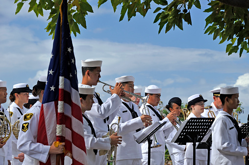 Honolulu, Hawaii, USA - December 8, 2011: Young musicians join naval band playing in Punch Bowl Cemetery