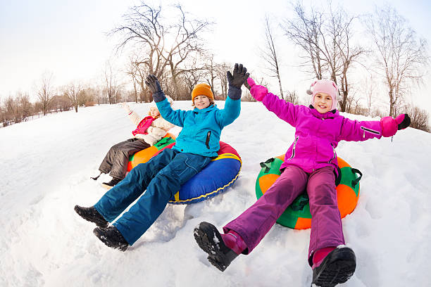 istock Children with arms up sliding down on the tubes 475150766