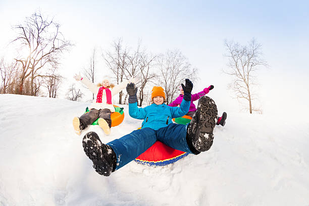 istock Boy and two girls sliding down on the tubes 475150770