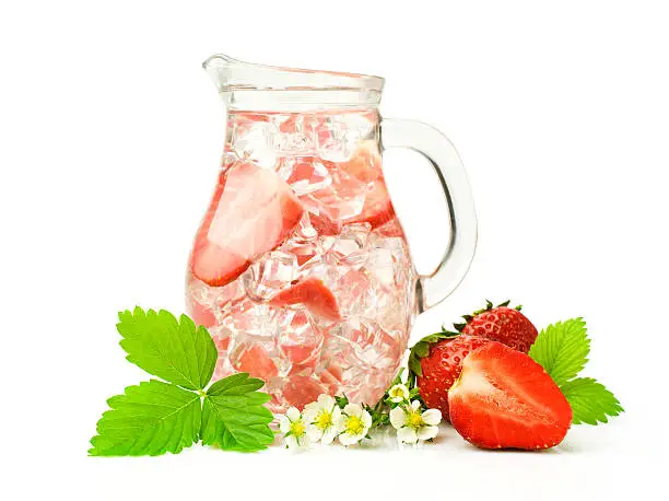 Refreshment beverage with strawberries and ice cubies isolated on white