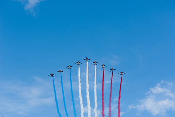 French air patrol - National Day Paris, France- July 14, 2011: French Air Patrol formation flying in a blue sky with blue, white and red vapor trails for the French National Day bastille day photos stock pictures, royalty-free photos & images
