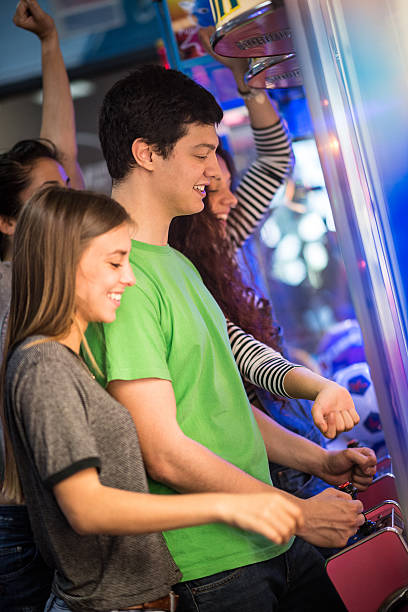istock Group of friends at the amusement arcade 475154870