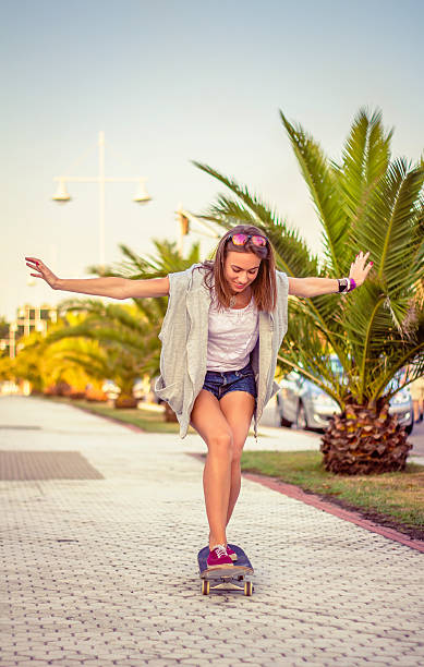 istock Young girl riding in a skateboard outdoors on summer 475156544