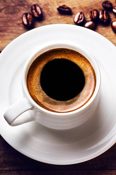 istock Coffee cup with white saucer and roasted cofee beans 475157599