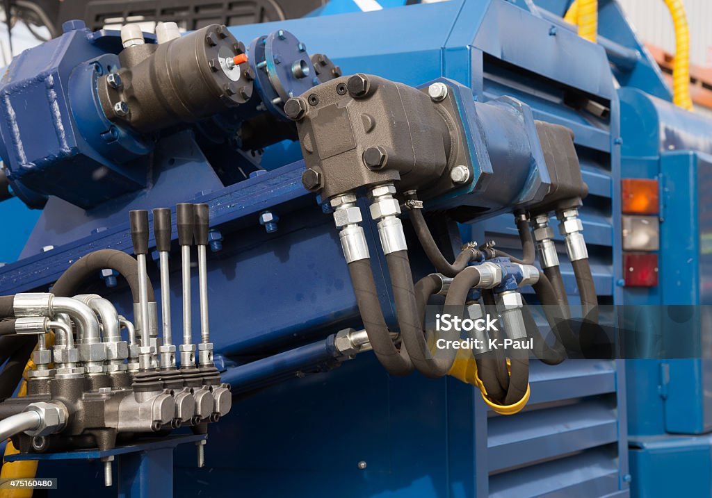 Hydraulic tubes, fittings and levers on control panel Hydraulic tubes, fittings and levers on control panel of lifting mechanism Hydraulic Platform Stock Photo