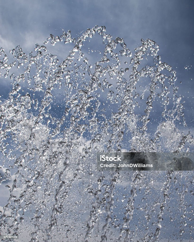 Water Fountain Spray Sprayed water from a water fountain against a blue sky 2015 Stock Photo