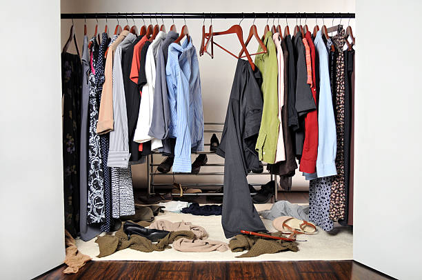 Woman's Messy and Unorganized Clothes Closet stock photo