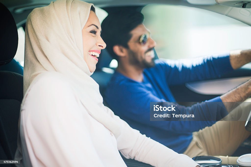 Middle eastern couple driving a luxury car in Dubai One beautiful couple driving a car. Car Stock Photo