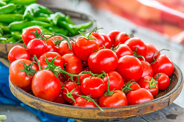 istock Organic Tomatoes in basket, market scene 475162998