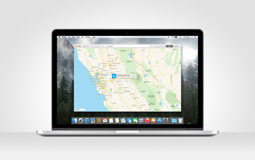 Varna, Bulgaria - November 03, 2013: Directly front view of Apple MacBook Pro Retina with an open Maps app on gray background. 