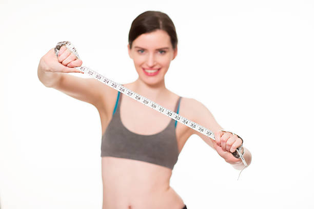 istock female with measuring tape 475170865
