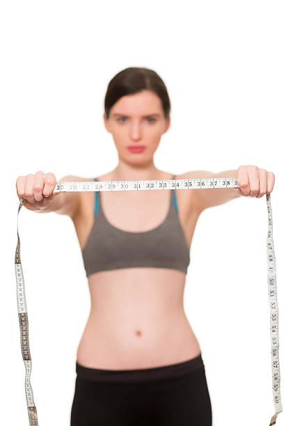 istock female with measuring tape 475171221