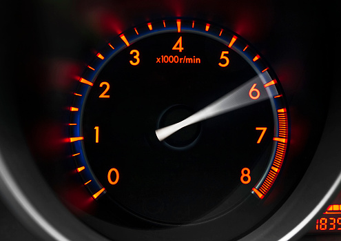 Close up shot of a revolution counter of a sport car showing engine revving 