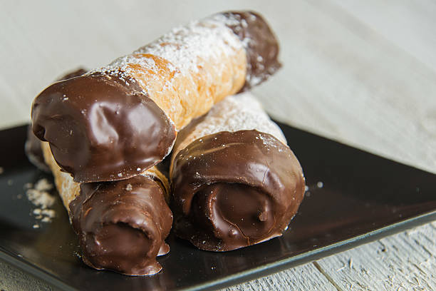 istock Canonchitos with Chocolate and Powerdered Sugar on Black Plate 475173070