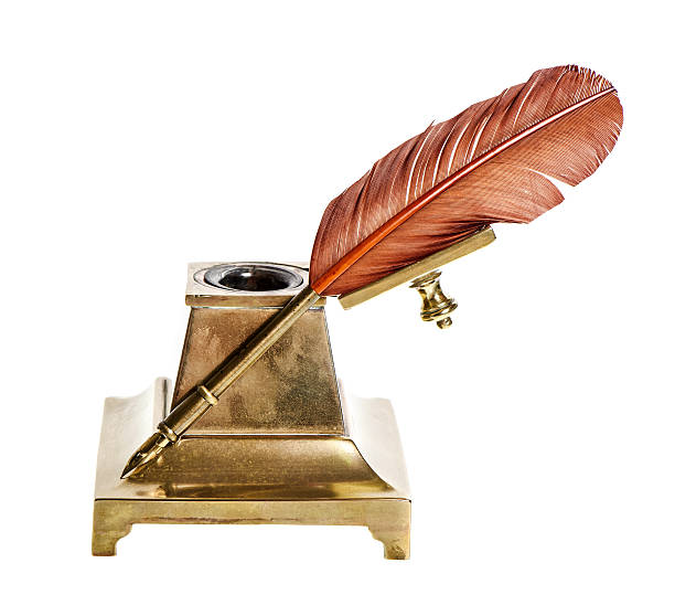 istock Feather pen with antique inkwell Isolated on white 475175649