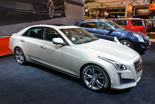 Amsterdam, The Netherlands - April 16, 2015: 2015 Cadilac CTS Sedan on display during the 2015 Amsterdam motor show. People in the background are looking at the cars.