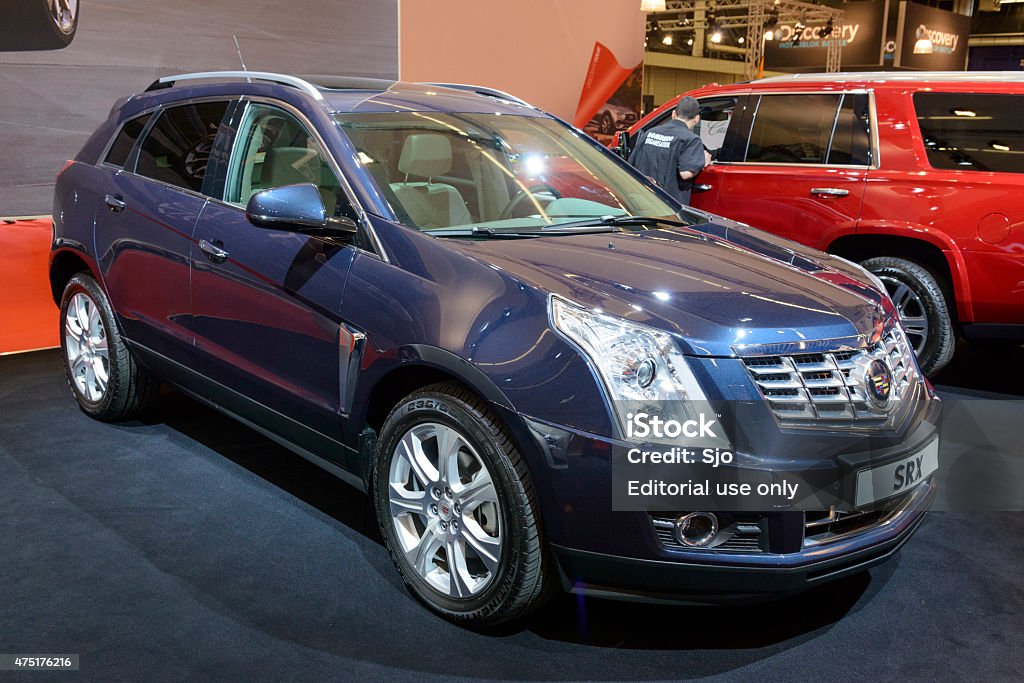 2015 Cadillac SRX crossover SUV Amsterdam, The Netherlands - April 16, 2015: 2015 Cadillac SRX crossover SUV on display during the 2015 Amsterdam motor show. People in the background are looking at the cars. 2015 Stock Photo